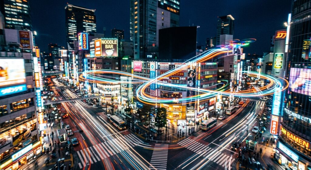 An artistically blurred long-exposure shot of light trails from a drone flying through a neon-lit ur