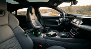A high-end, professional editorial shot of a sleek drone battery charger plugged into a modern car’s